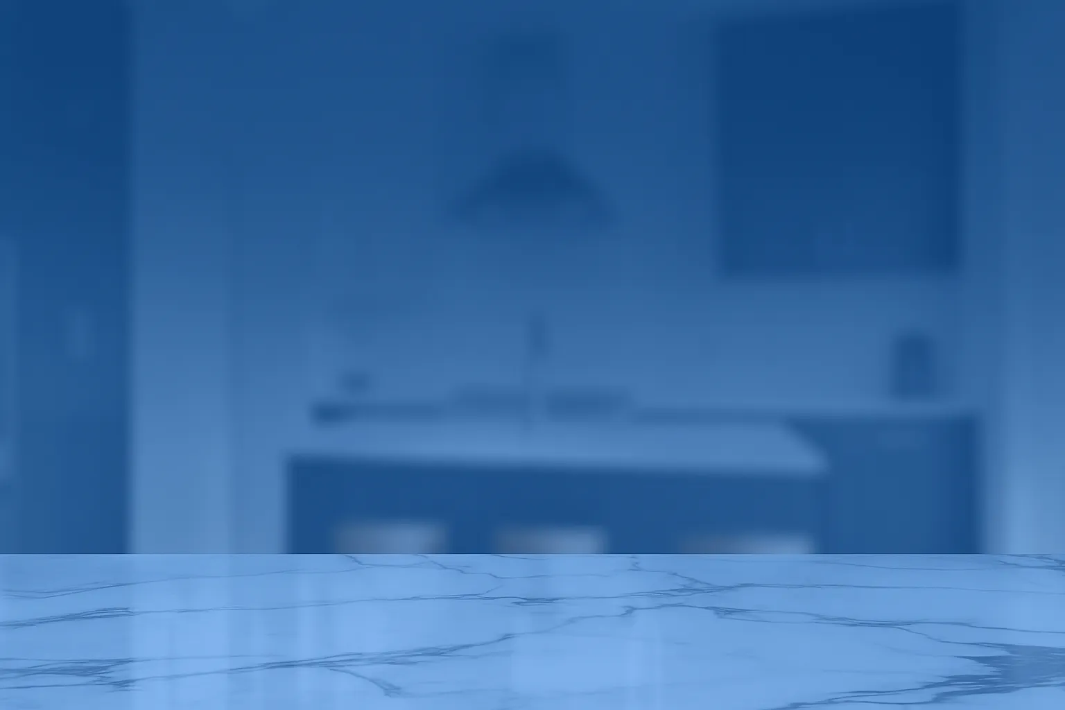 Modern kitchen with a polished marble countertop in the foreground and a softly blurred blue background, symbolizing the beauty, durability, and everyday function of custom countertops featured by CCMW.