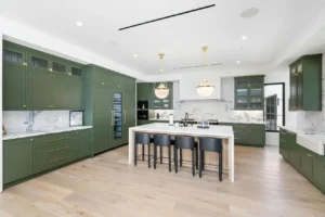 High-end custom green kitchen cabinets with luxury finishes and brass hardware